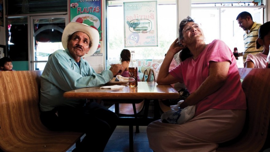 An elderly couple sit down to lunch in a restaurant in Ciudad Juárez. Despite fl