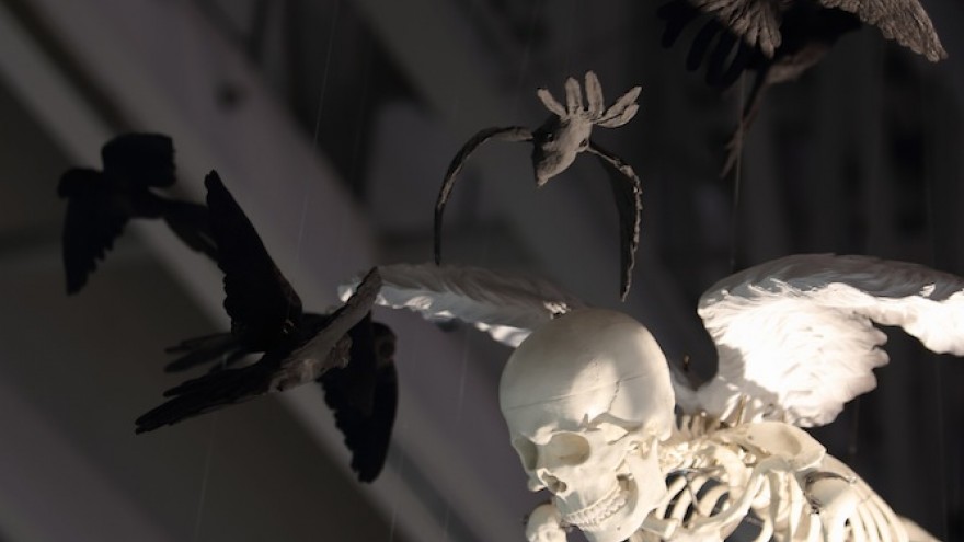 Skeleton mobile with black birds above Sobeit Studio's stand. 
