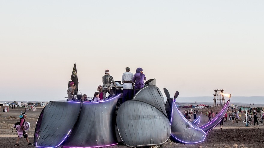 The rhino art car was one of the moving parties, playing music in the desert.