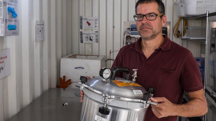Rice University Professor Douglas Schuler holds a steam-activated autoclave used to sterilize surgical instruments in the Sterile Box developed at Rice for use in low-resource settings. (Credit: Jeff Fitlow/Rice University) 
