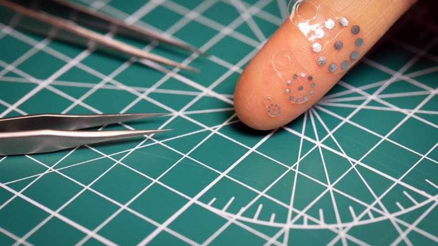 Image: Three variations of the soft, flexible ultrasound sticker device displayed on a finger. Image by Jiaqi Liu