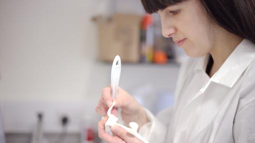 Susannah Clarke checks one of the 3D printed surgical guides.