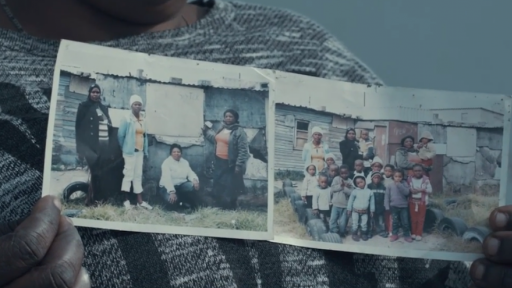 Principal of Three Sisters Educare holds up photos of the tiny shack where she started the school with 10 children.