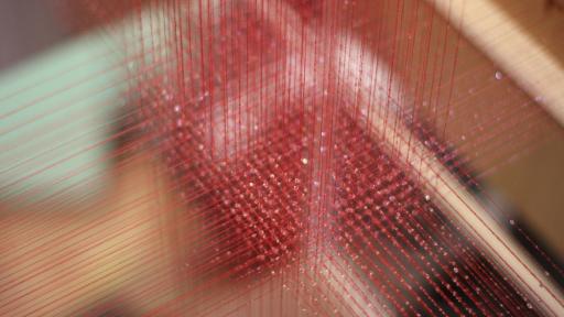 3D-weaving involves crisscrossing three-dimensional red strings