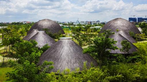 Vietnamese studio Vo Trong Nghia Architects have constructed eight thatched-roof domes that serve as a multi-functional community centre.