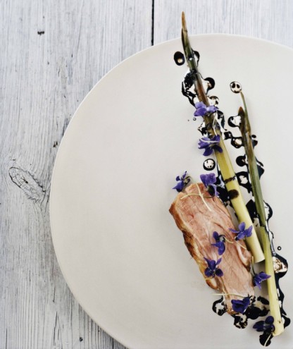 Pork neck with bulrushes, violets and malt. From Noma: Time and Place in Nordic Cuisine. Photo by Ditte Isager. Courtesy of Phaidon Press, www.phaidon.com