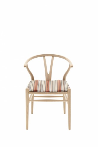 Paul Smith redesigns Carl Hansen & Son's iconic Shell Chair in collaboration with Maharam. 