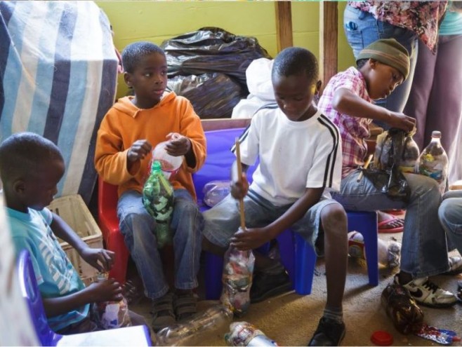 Young boys in Walmer Township take part in the community effort involved in making EcoBricks.