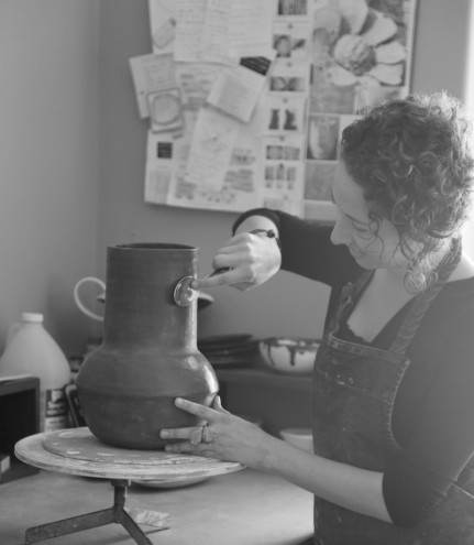 Working at her home studio, burnishing a vessel vase from the Africa-inspired The Berg Collection to give it shine. Image: Inness Mass.