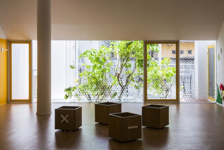 Kientru O Architects converted this building from an old townhouse into a vibrant ochre-and-yellow themed nursery school. 