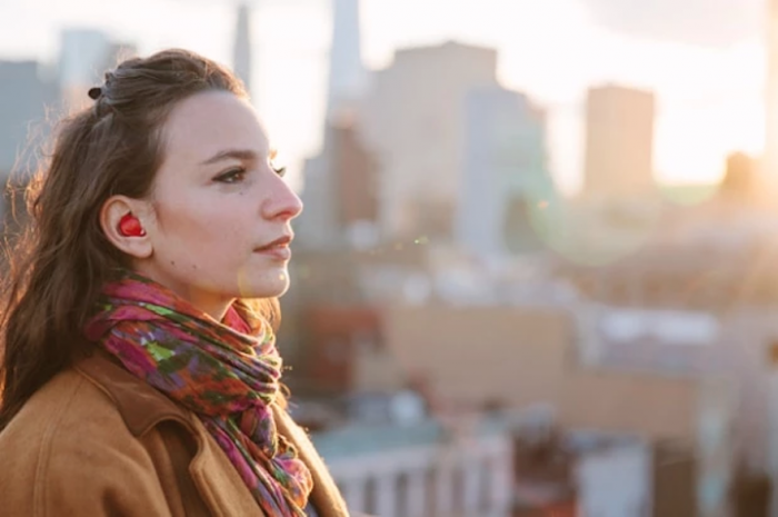 Furturistic earpiece translates conversations in real-time.