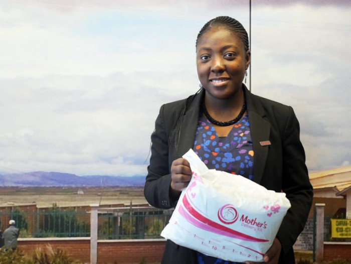 Adepeju Jaiyeoba holding a Mother's Delivery Kit 