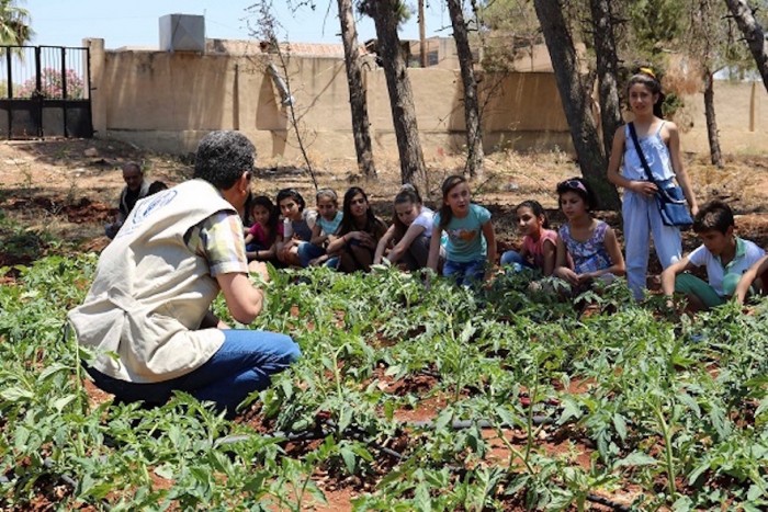 Nutrition education is key. School children and FAO staff discuss nutrition at a school garden in Hama, Syria. ©FAO/Wajdi Skaf