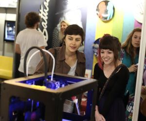Design Indaba Expo 2014 visitors look on as Ignite 3D's Makerbot prints a 3D object. 