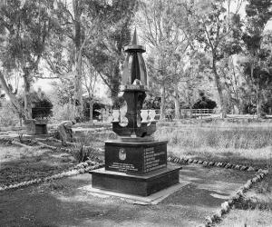  A modest square, carefully tended by the municipality, sown, at the time of this photograph with blue daisies, the borders of its paths neatly outlined by beer bottles. It is a memorial to local heroes killed in the struggle against apartheid.  Steynsberg, Eastern Cape. Image: David Goldblatt. 