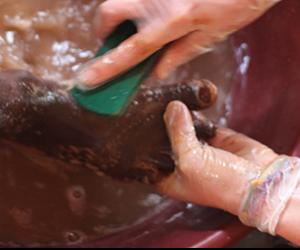 Volunteer washing feet for Sole Hope in Uganda 