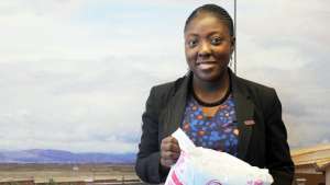 Adepeju Jaiyeoba holding a Mother's Delivery Kit 