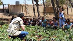 Nutrition education is key. School children and FAO staff discuss nutrition at a school garden in Hama, Syria. ©FAO/Wajdi Skaf