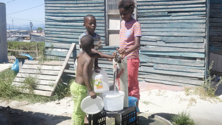 Children at a public water tap (emthonjeni) in Monwabisi Park, Khayelitsha