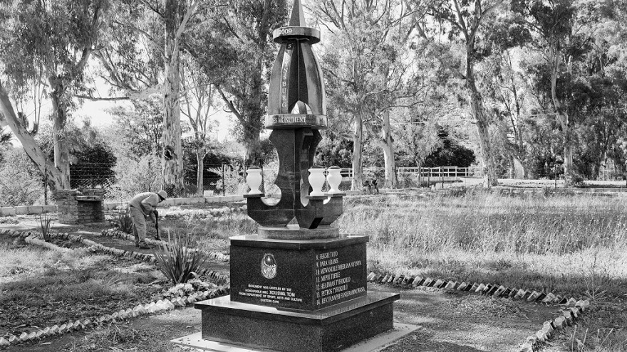  A modest square, carefully tended by the municipality, sown, at the time of this photograph with blue daisies, the borders of its paths neatly outlined by beer bottles. It is a memorial to local heroes killed in the struggle against apartheid.  Steynsberg, Eastern Cape. Image: David Goldblatt. 