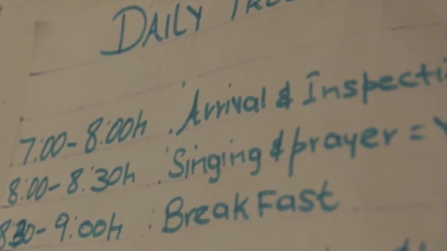 The children's daily schedule is handwritten and hangs on the wall in the classroom.