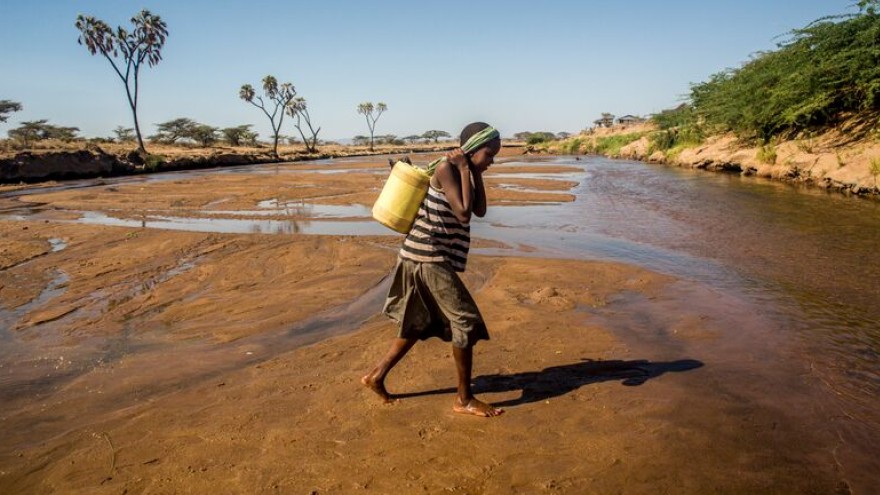 9-year-old Asunta collects water from the Uaso Nyiro River.