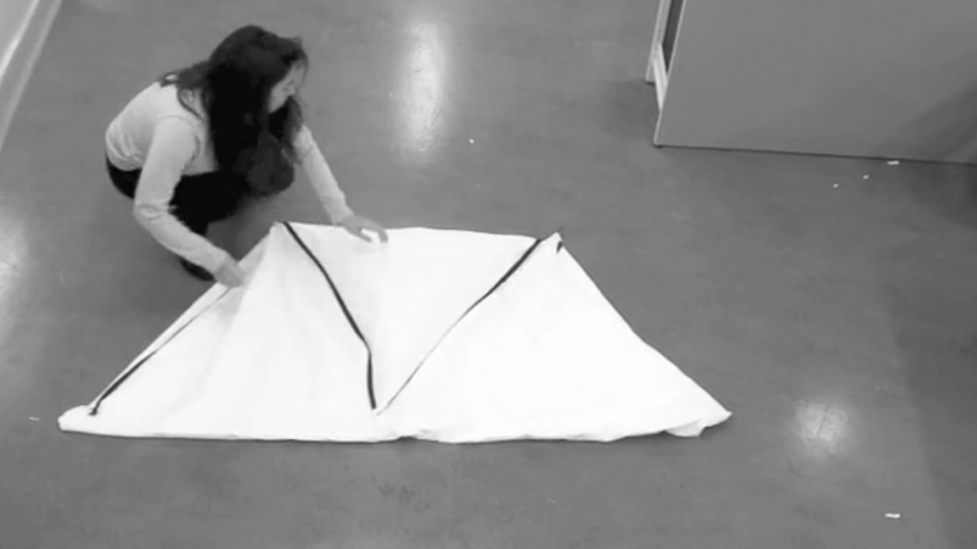 Students at the Royal College of Art have designed a garment that can turn into a shelter for an adult and a child