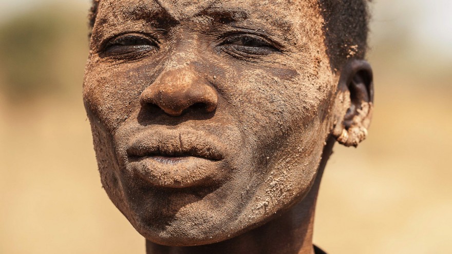 A Mundari woman with the ritual facial scarring, typical of their tribe, and covered in ash, a natural antiseptic which also protects the skin from insects and the sun. Image: © Tariq Zaidi / ZUMA Press