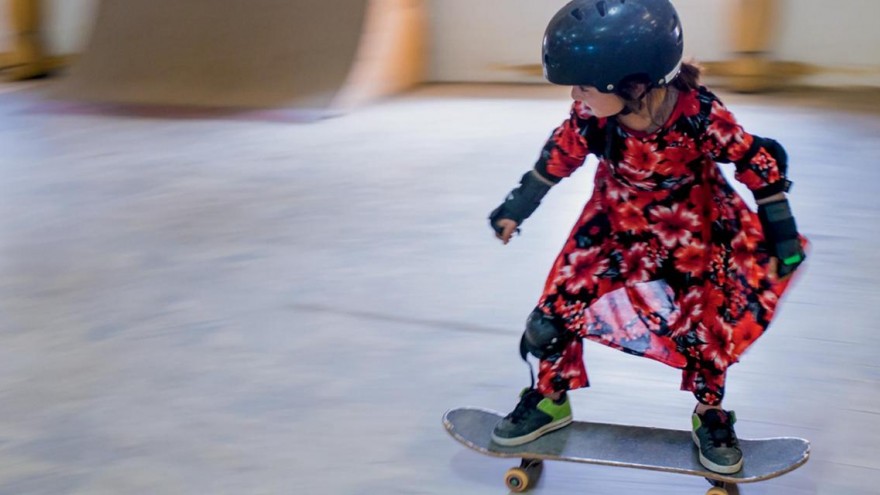 Small girl riding skateboard