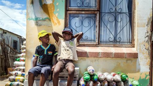 Two small children from Walmer Township in Port Elizabeth sit next to the EcoBricks that have been made for the Penguins Play and learn Centre. Image: https://www.thundafund.com/ecobrickexchange