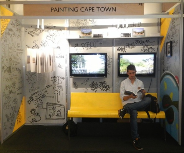 Matthew Olckers on his stand at Design Indaba Expo 2014. The stand design was inspired by the Metro train interiors in the signature grey and yellow. 