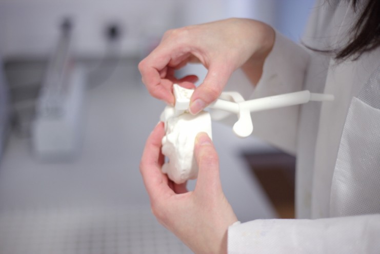 Susannah Clarke checks one of the 3D printed surgical guides.