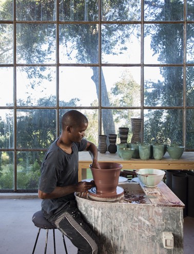 Ceramicist Chuma Maweni works at the potter's wheel at Art In The Forest in Constantia. Image curtesy of Jac de Villliers.