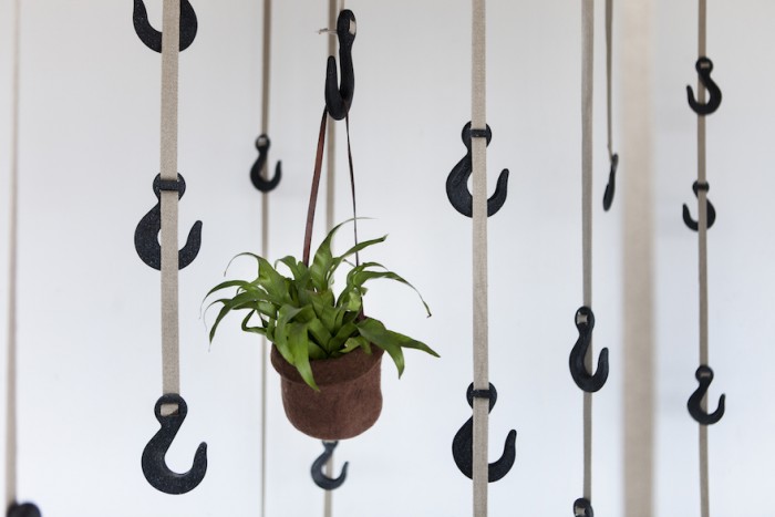 Ryan Frank upcycles plastic and grass to create a useful hanging storage. 