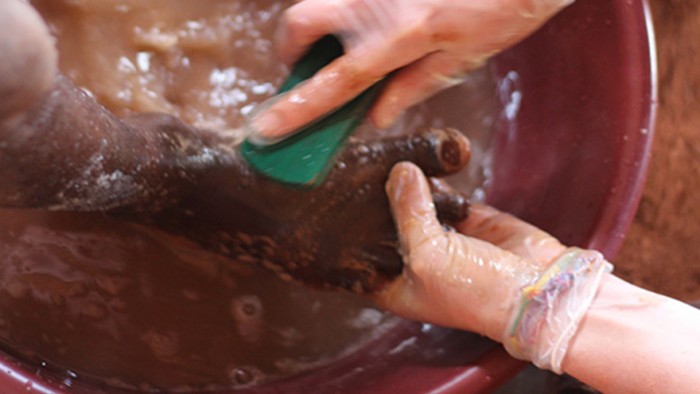 Volunteer washing feet for Sole Hope in Uganda 