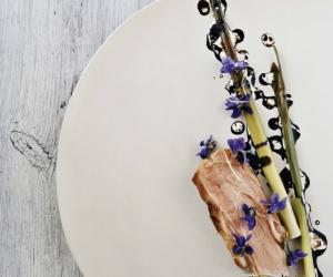 Pork neck with bulrushes, violets and malt. From Noma: Time and Place in Nordic Cuisine. Photo by Ditte Isager. Courtesy of Phaidon Press, www.phaidon.com