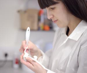 Susannah Clarke checks one of the 3D printed surgical guides.