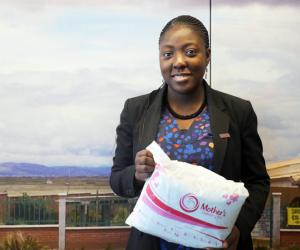 Adepeju Jaiyeoba holding a Mother's Delivery Kit 