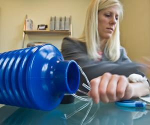 Danielle Zurovcik demonstrates how to use the negative pressure pump to seal an arm wound. Photo: Melanie Gonick.