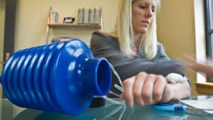 Danielle Zurovcik demonstrates how to use the negative pressure pump to seal an arm wound. Photo: Melanie Gonick.